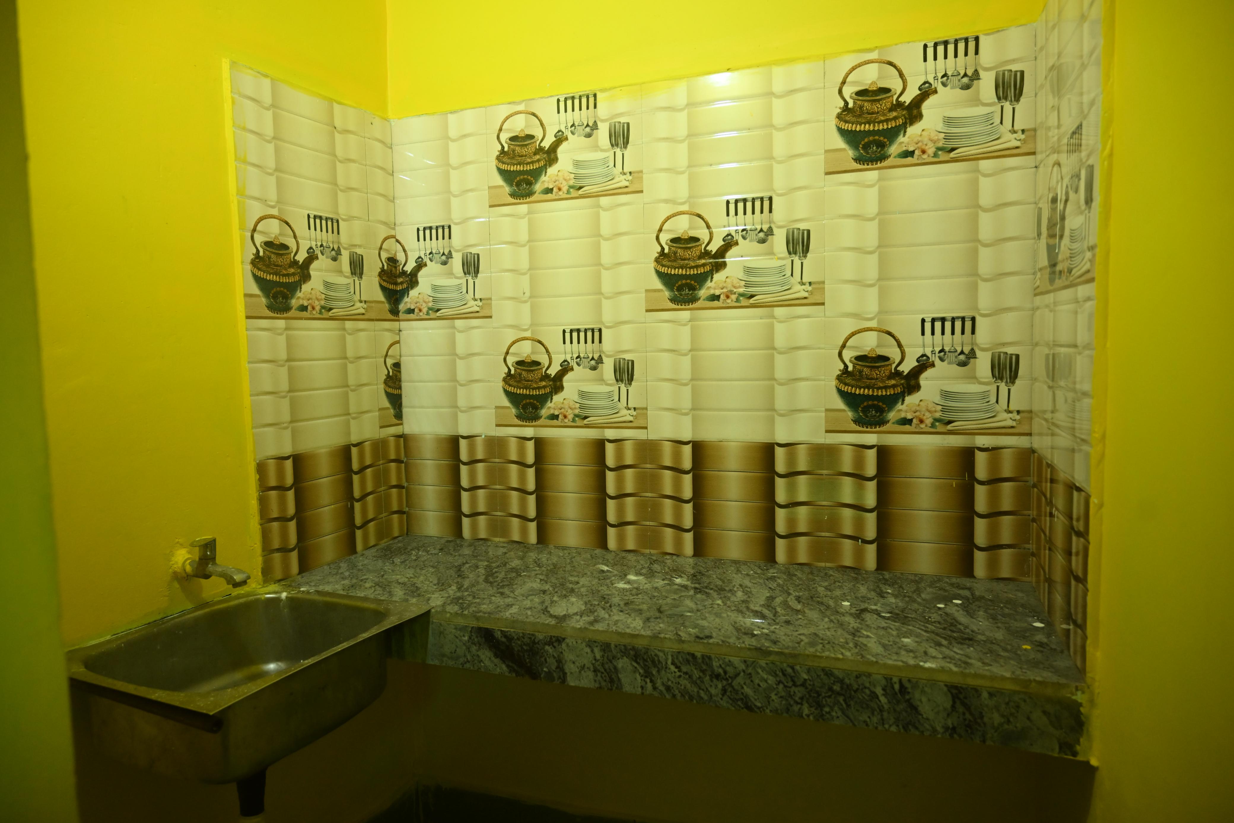 Sunnyasort attached bathroom with blue patterned tiles